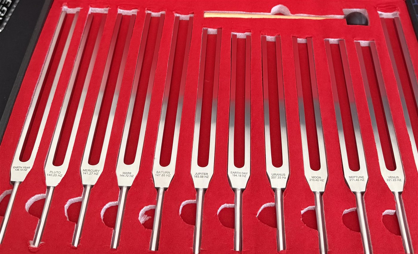 The twelve-piece unweighted Sacred Tones set in its case, each fork engraved.
